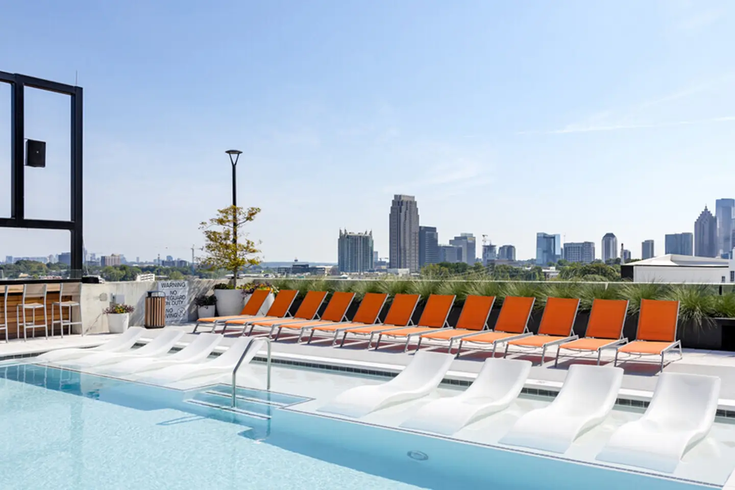 resort-style swimming pool with poolside lounge seating